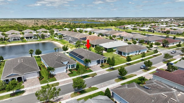 birds eye view of property with a water view and a residential view