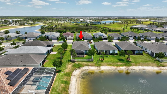 drone / aerial view featuring a water view and a residential view