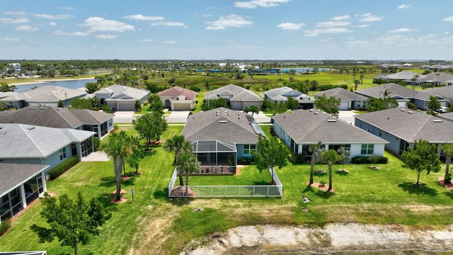 birds eye view of property featuring a water view and a residential view