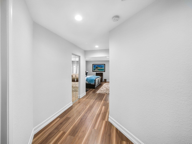 8659 Thousand Pines Cir, West Palm Beach, FL 33411 - hallway with baseboards, dark wood-type flooring, and recessed lighting