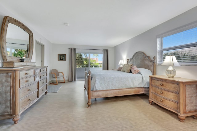 3212 NE 12th St Unit 201, Pompano Beach, FL 33062 - bedroom with light wood-type flooring, access to exterior, multiple windows, and baseboards