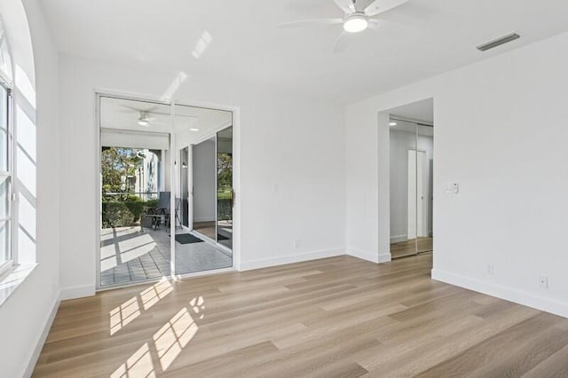unfurnished room featuring a ceiling fan, wood finished floors, and baseboards
