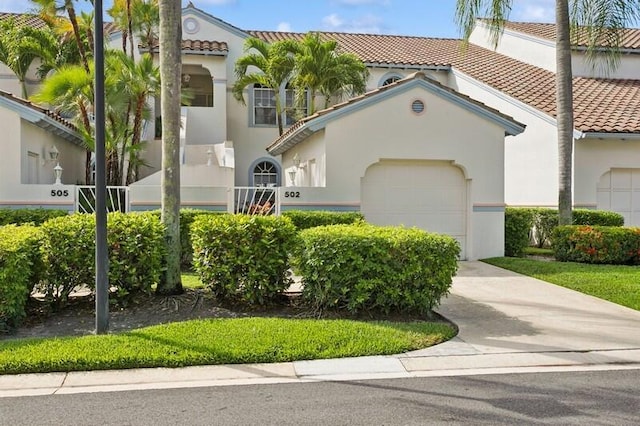 view of front of home featuring a tile roof, stucco siding, concrete driveway, and a garage