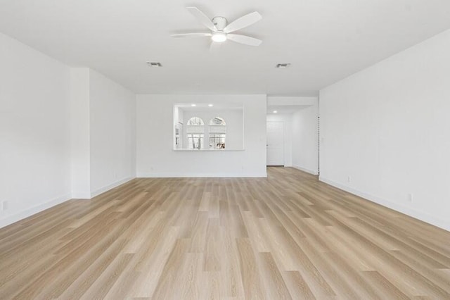 unfurnished living room featuring a ceiling fan, light wood-type flooring, and baseboards