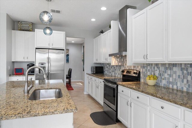 11400 SW Reston Ct, Port Saint Lucie, FL 34987 - kitchen featuring stainless steel appliances, backsplash, white cabinetry, light stone countertops, and light tile patterned floors