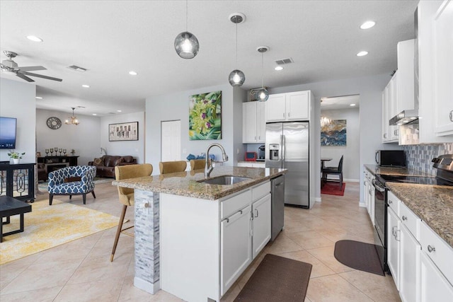 11400 SW Reston Ct, Port Saint Lucie, FL 34987 - kitchen featuring appliances with stainless steel finishes, open floor plan, light tile patterned flooring, ceiling fan, and recessed lighting
