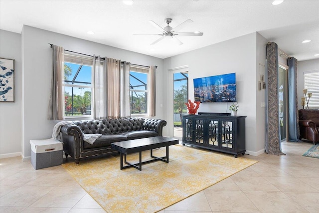 living room with light tile patterned floors, baseboards, recessed lighting, and ceiling fan