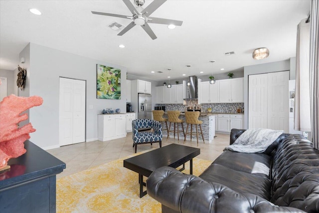 living room featuring ceiling fan, light tile patterned flooring, recessed lighting, and baseboards