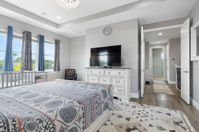 bedroom with wood finished floors, recessed lighting, and baseboards