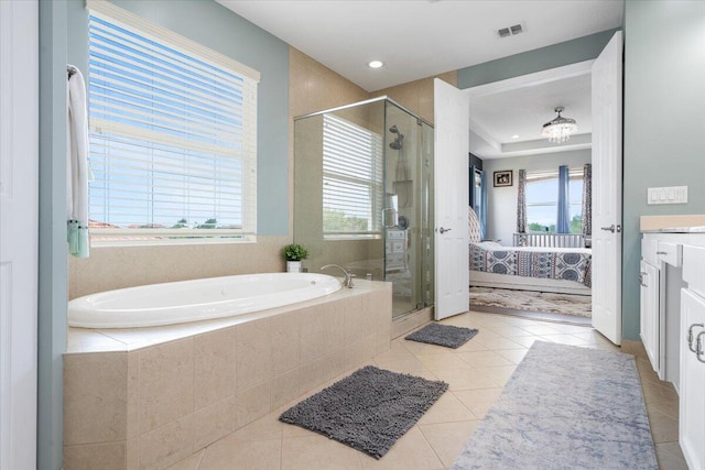 bathroom featuring connected bathroom, tile patterned floors, a shower stall, plenty of natural light, and recessed lighting