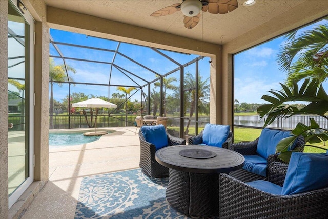 view of patio with a ceiling fan, a water view, and a lanai