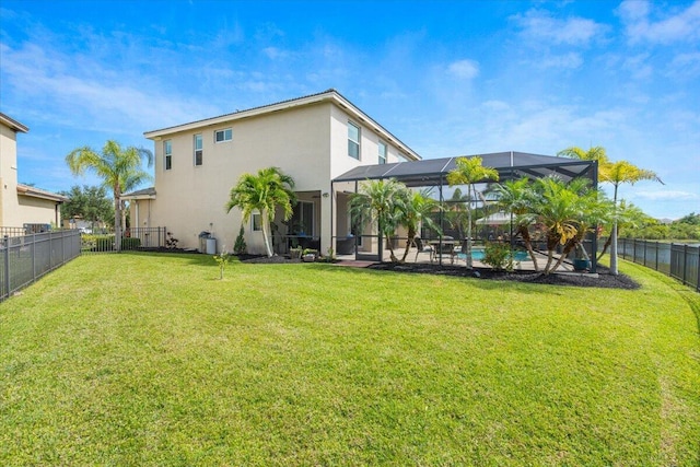 11400 SW Reston Ct, Port Saint Lucie, FL 34987 - rear view of property featuring stucco siding, a fenced backyard, glass enclosure, and a patio area