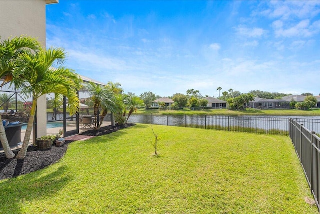view of yard featuring a water view, a lanai, and a residential view