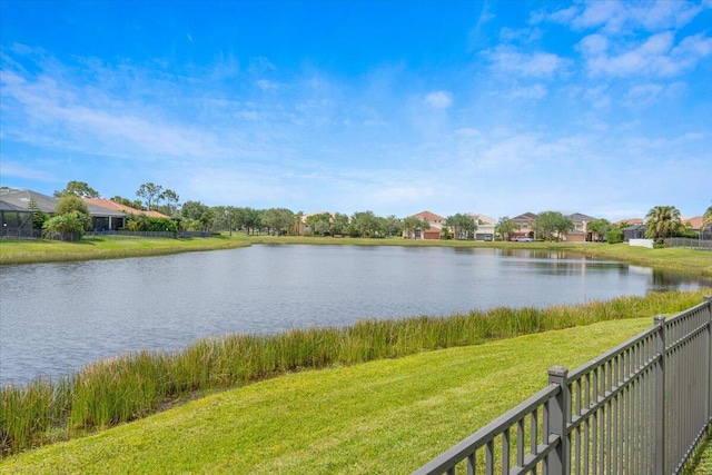 water view with fence and nearby suburban area