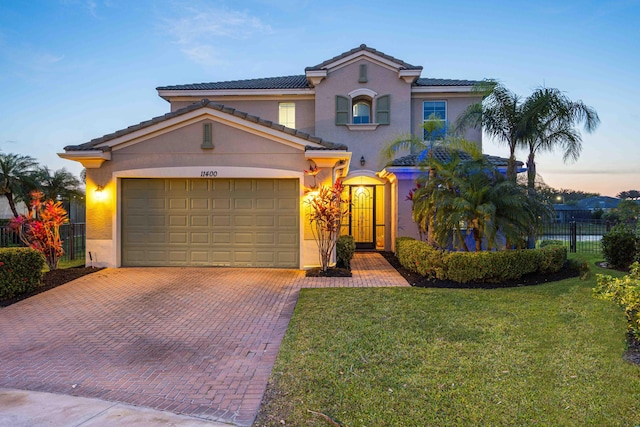 11400 SW Reston Ct, Port Saint Lucie, FL 34987 - mediterranean / spanish house with decorative driveway, stucco siding, a garage, and a tile roof