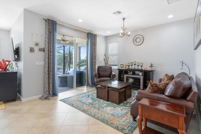 living area with a chandelier, light tile patterned floors, recessed lighting, and baseboards