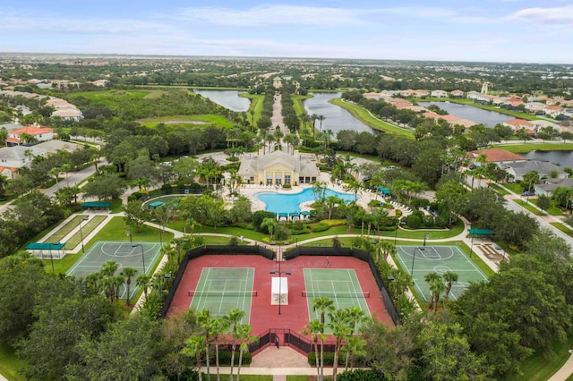 aerial perspective of suburban area with a large body of water and a pool