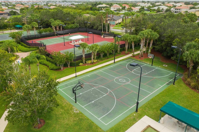 view of basketball court featuring community basketball court, fence, and a tennis court