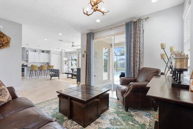 living room featuring healthy amount of natural light, a chandelier, recessed lighting, ceiling fan, and light tile patterned flooring