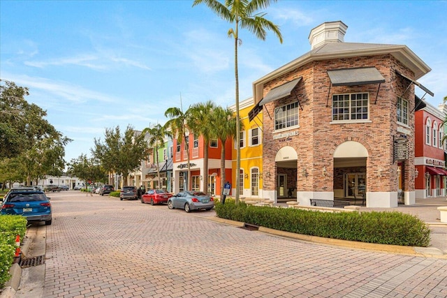 11400 SW Reston Ct, Port Saint Lucie, FL 34987 - view of decorative street with curbs, street lights, and sidewalks
