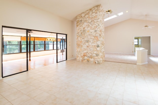 3984 SE Fairway E, Stuart, FL 34997 - empty room featuring a ceiling fan, high vaulted ceiling, a skylight, and a healthy amount of sunlight