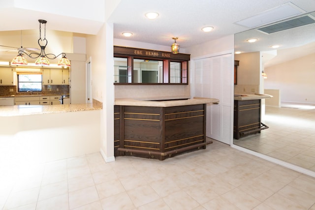 3984 SE Fairway E, Stuart, FL 34997 - kitchen with recessed lighting, decorative backsplash, cream cabinets, and visible vents