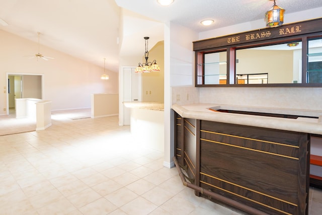 3984 SE Fairway E, Stuart, FL 34997 - bar with a ceiling fan, decorative light fixtures, light tile patterned floors, baseboards, and lofted ceiling