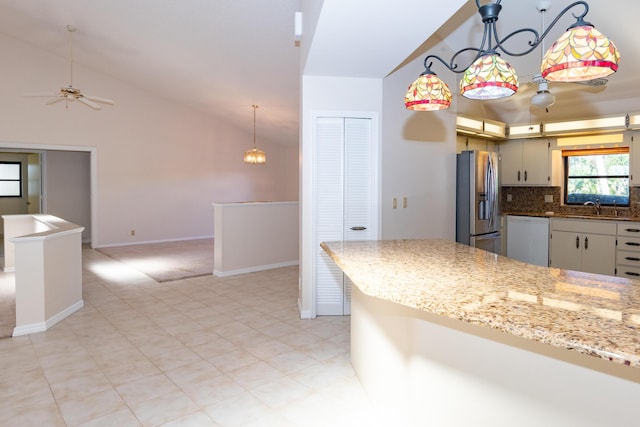 3984 SE Fairway E, Stuart, FL 34997 - kitchen featuring a ceiling fan, white dishwasher, stainless steel fridge, a sink, and backsplash