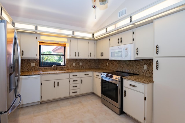 3984 SE Fairway E, Stuart, FL 34997 - kitchen featuring visible vents, a sink, dark stone countertops, backsplash, and stainless steel appliances