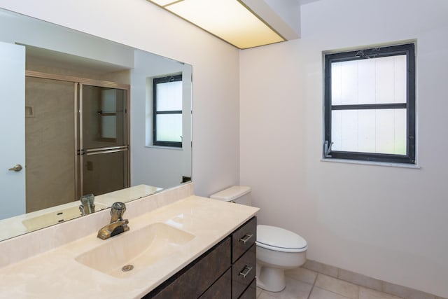 3984 SE Fairway E, Stuart, FL 34997 - bathroom featuring vanity, toilet, tile patterned floors, and a stall shower