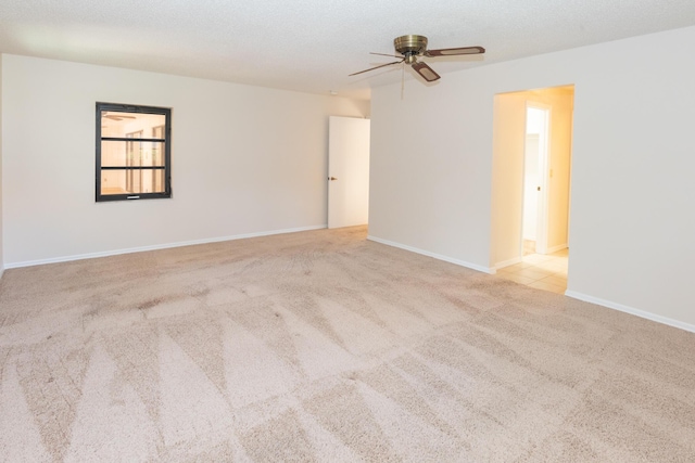 3984 SE Fairway E, Stuart, FL 34997 - unfurnished room with carpet floors, ceiling fan, and baseboards