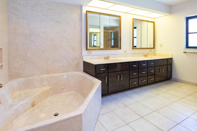 3984 SE Fairway E, Stuart, FL 34997 - bathroom featuring a jetted tub, double vanity, a sink, and tile patterned flooring