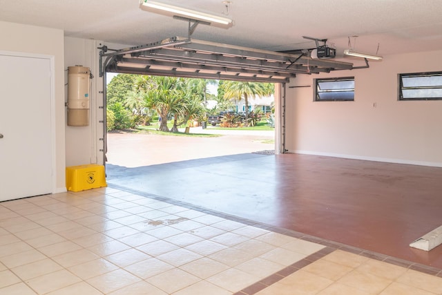 3984 SE Fairway E, Stuart, FL 34997 - garage featuring baseboards and a garage door opener