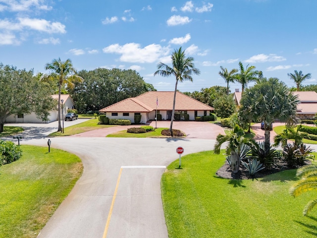 3984 SE Fairway E, Stuart, FL 34997 - view of community with curved driveway and a yard