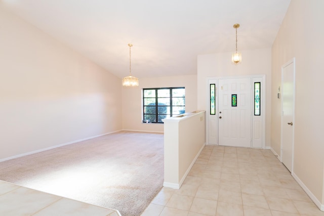3984 SE Fairway E, Stuart, FL 34997 - foyer entrance with baseboards, light colored carpet, and a chandelier