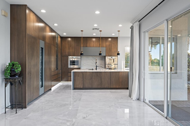 kitchen featuring modern cabinets, recessed lighting, oven, and light countertops