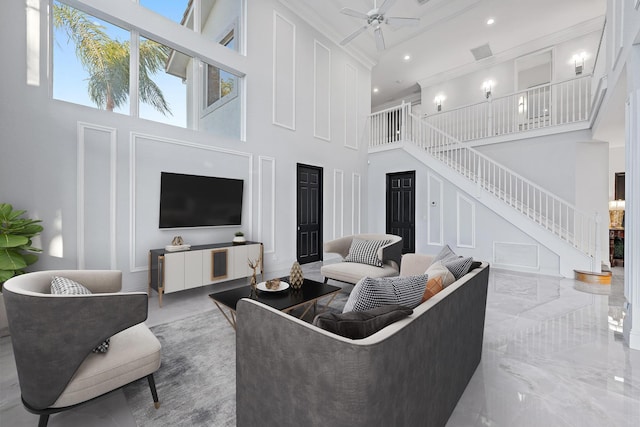 living room with recessed lighting, a high ceiling, ornamental molding, stairs, and ceiling fan