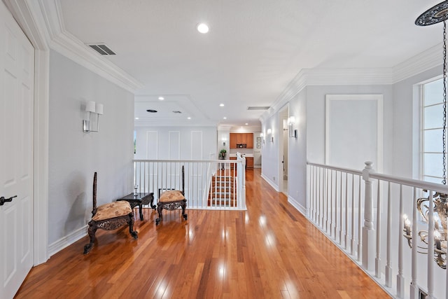 hall with recessed lighting, light wood-style floors, visible vents, and baseboards