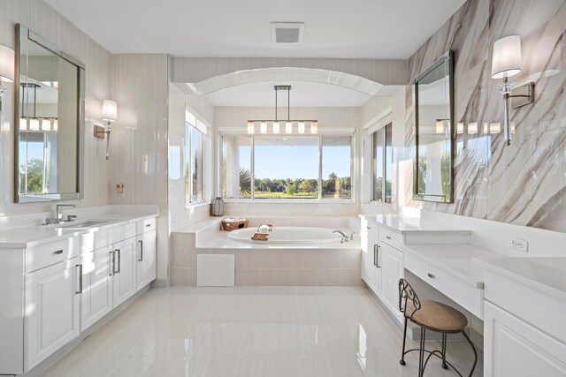 full bathroom featuring a bath, a sink, visible vents, and plenty of natural light