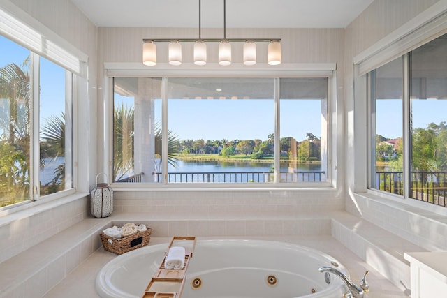 bathroom with a jetted tub and a water view
