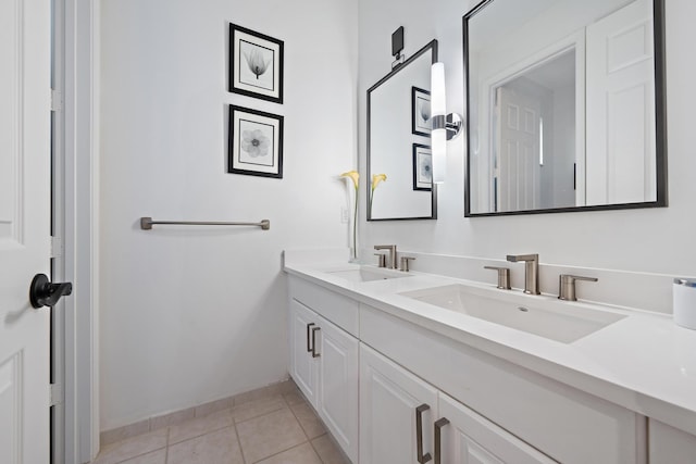 full bathroom featuring baseboards, tile patterned floors, a sink, and double vanity