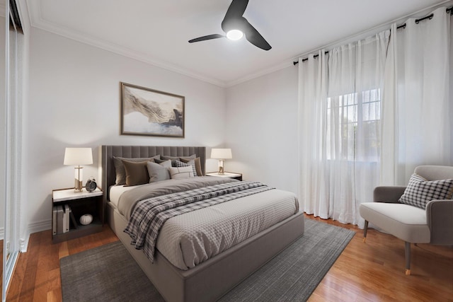bedroom with ceiling fan, wood finished floors, and ornamental molding