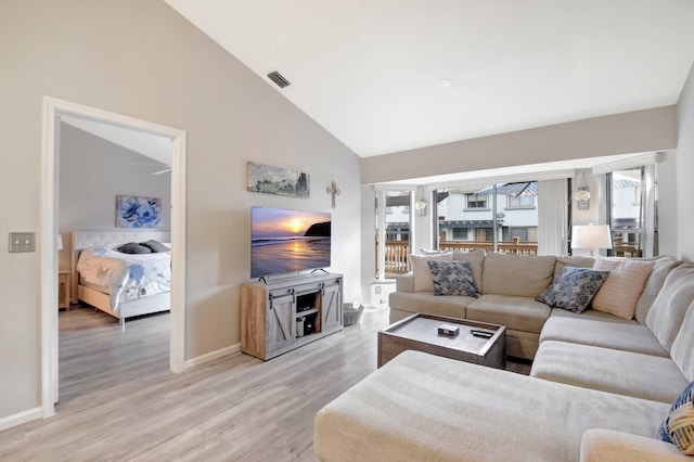 2406 Landings Blvd, Greenacres, FL 33413 - living room featuring light wood-style floors, baseboards, and high vaulted ceiling