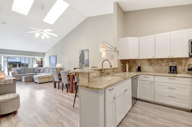 2406 Landings Blvd, Greenacres, FL 33413 - kitchen with a sink, high vaulted ceiling, appliances with stainless steel finishes, a peninsula, and a breakfast bar