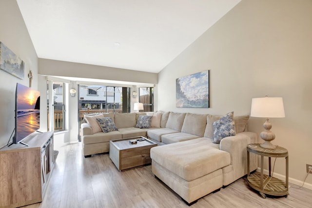 2406 Landings Blvd, Greenacres, FL 33413 - living area featuring light wood finished floors, baseboards, and high vaulted ceiling