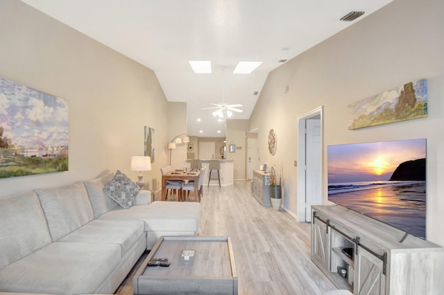 2406 Landings Blvd, Greenacres, FL 33413 - living area featuring lofted ceiling, light wood finished floors, a ceiling fan, a skylight, and baseboards
