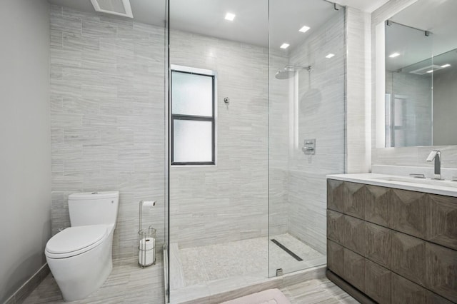 2409 NE 18th Ave, Wilton Manors, FL 33305 - bathroom featuring tiled shower, toilet, vanity, and tile walls