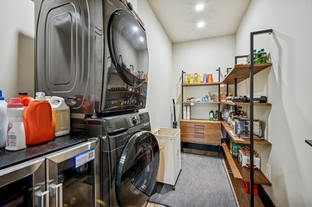 2409 NE 18th Ave, Wilton Manors, FL 33305 - laundry room featuring estacked washer and dryer, wood finished floors, and wine cooler