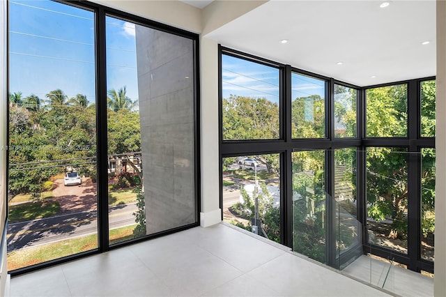 doorway to outside with a wall of windows, a wealth of natural light, and recessed lighting