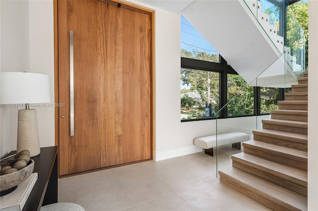 staircase featuring baseboards